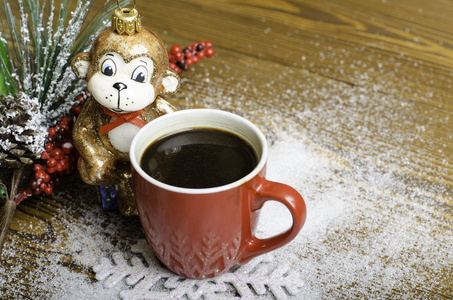 圣诞猴子附近一个红色的咖啡杯图片