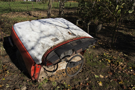 在秋天阳光明媚的日子里, 锈迹斑斑的老爷车被砍成两半