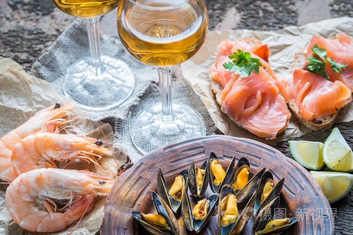 用两杯白葡萄酒在木桌上的海鲜