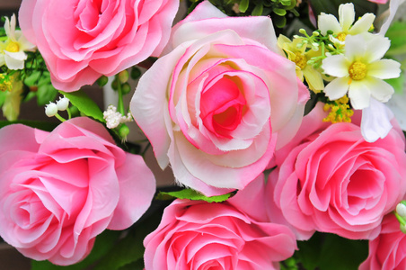 人工粉红色的玫瑰和叶背景