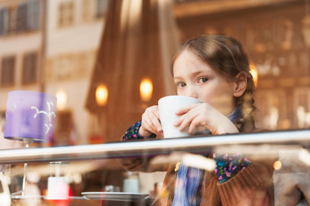 小女孩在咖啡馆喝热巧克力图片