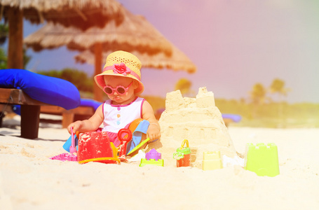 可爱的小女孩，建筑在沙滩上的堆沙堡