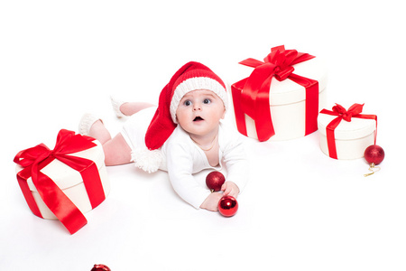 可爱的婴儿戴着红色的新年帽子，脸上挂着微笑，躺着