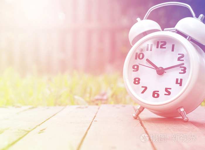 经典的闹钟在木材自然背景