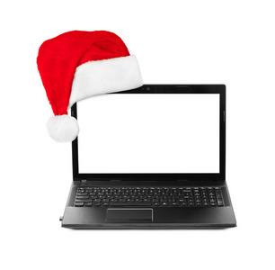 笔记本计算机和圣诞老人红色圣诞帽子