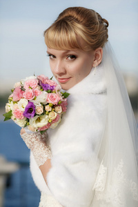 美丽的新娘穿着白色的皮毛外套图片