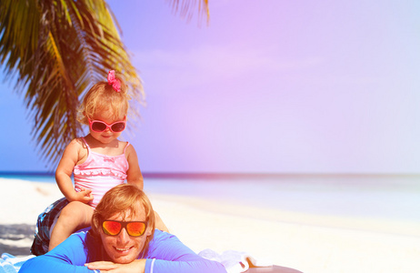 快乐的父亲和可爱的小女儿在海滩