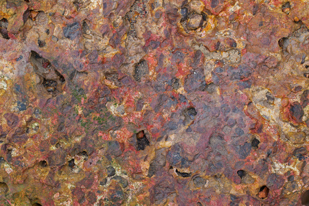 锈迹斑斑的红色红土砖石的纹理背景照片