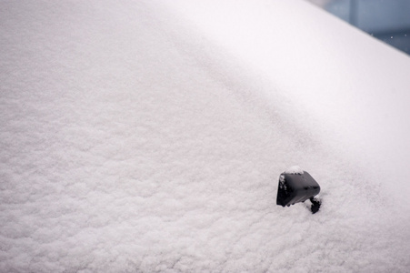 汽车覆盖在雪与机翼镜子显示通过雪