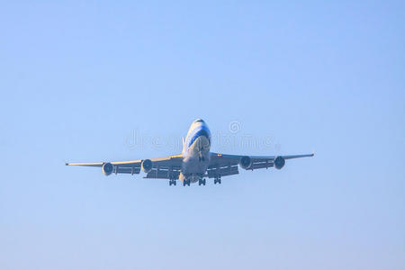 蓝天背景下准备降落在机场跑道上的客机