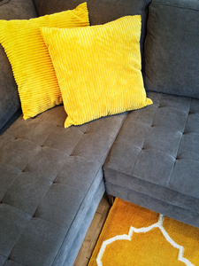 灰色的沙发上，与黄色座垫