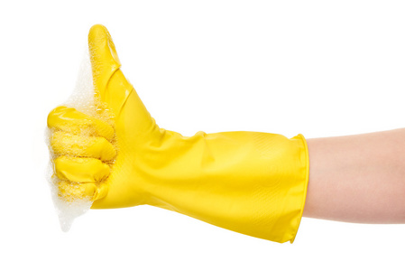 在泡沫显示大拇指黄色防护橡胶手套的手