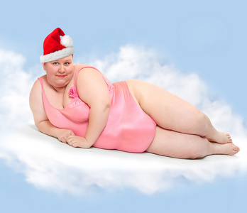 肥胖女人与圣诞老人的帽子图片