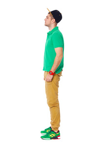 通体侧面肖像的年轻人站在工作室孤立无援照片