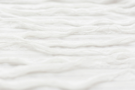 抽象的纺织背景。原单缎带装饰白色织物