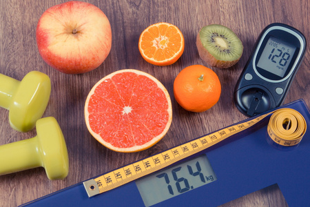 电子秤和血糖仪与结果的测量 厘米 健康食品 哑铃，健康的生活方式，糖尿病和减肥概念