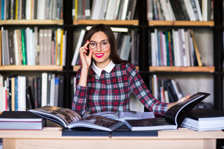 戴着眼镜在图书馆看书的女学生