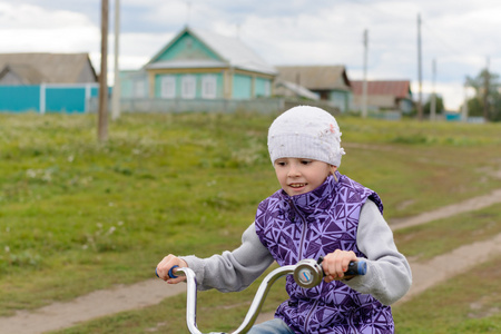在紫色背心女孩骑他的自行车图片