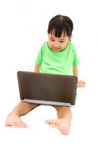 中国小女孩坐在地板上的笔记本电脑上
