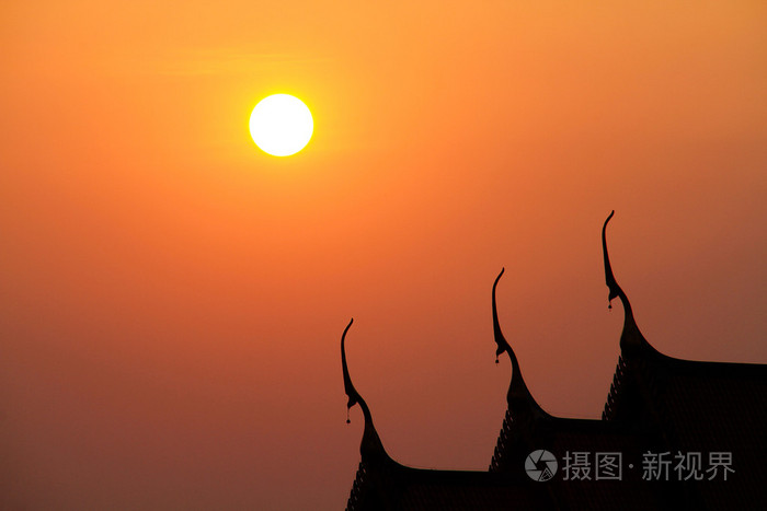 在金色的夕阳背景泰国寺庙屋顶的轮廓