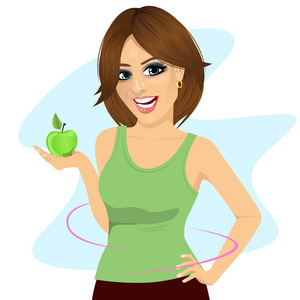年轻女子拿着一个绿色的苹果，瘦腰