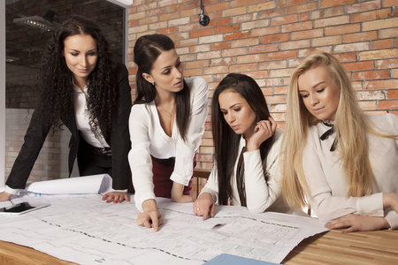 四个女企业家在办公室使用笔记本电脑