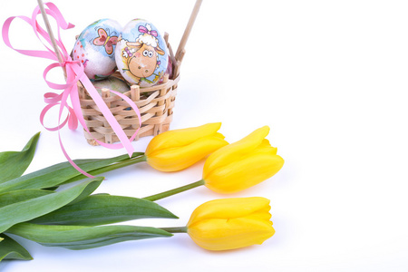 篮子和黄色的郁金香，在白色的复活节彩蛋