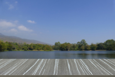 空的木桌山和在公园池塘和模糊 b