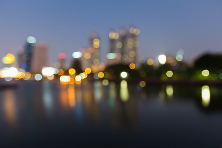 夜观模糊散景灯市市中心和水的倒影