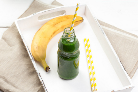 健康的绿色果汁，木制的桌子上