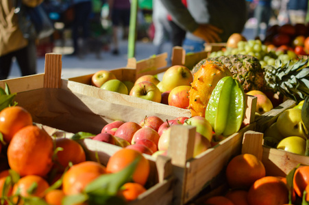 许多不同的水果，农民在市场的背景。买入和卖出