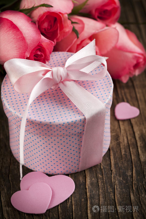 一束粉红色的玫瑰和礼品盒