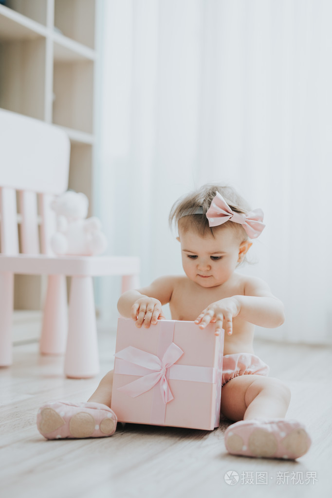 可爱的小宝贝女孩早晨用玩具在白色的房间里玩