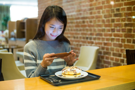 女人拍照的她的食物的