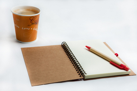 咖啡馆里的纸杯咖啡和笔记本早餐
