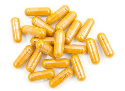 姜黄胶囊溢了出来,一瓶上 whi 孤立照片