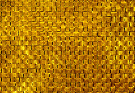 黄金质地的皮革编织。金色背景