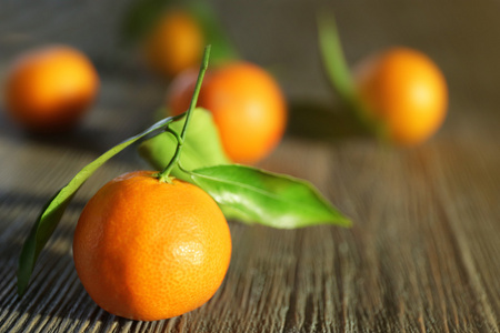 新鲜的橘子有叶子的木桌前，特写