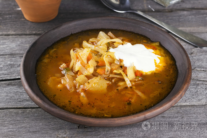 俄罗斯白菜汤中粘土板上深色的木质背景