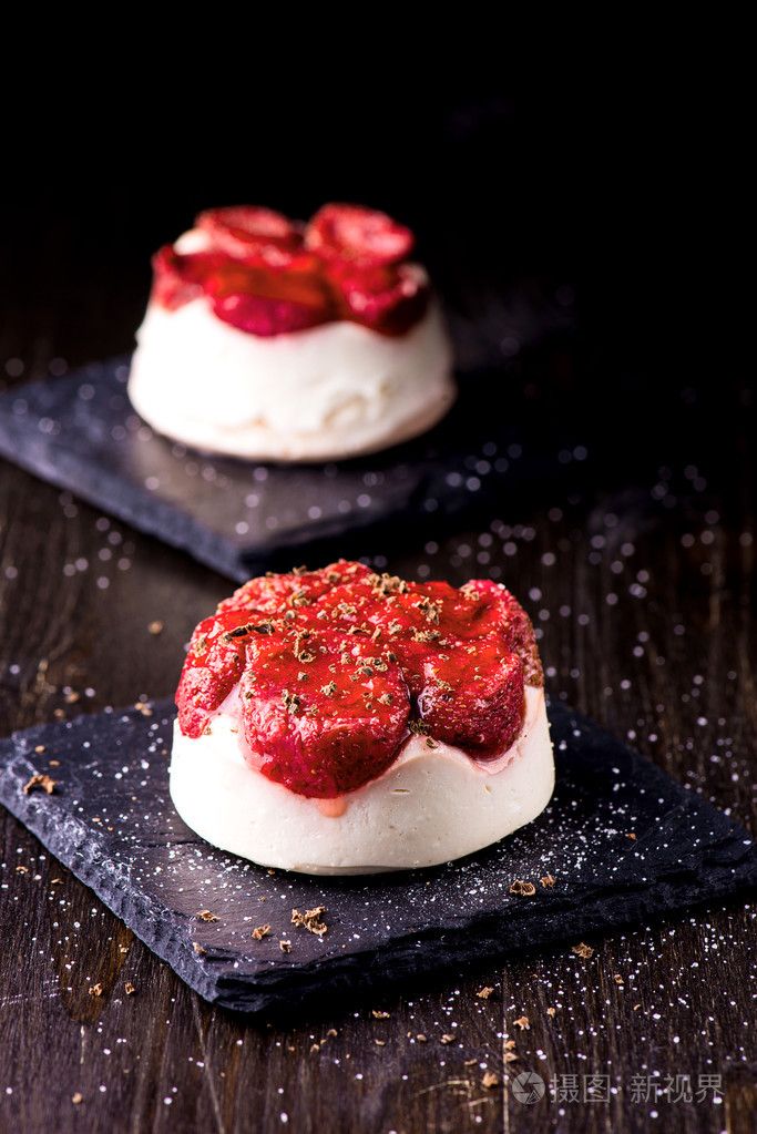 在黑色背景上的草莓奶酪甜点