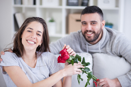 jeune homme, ce qui donne une rose rouge  sa petite amie