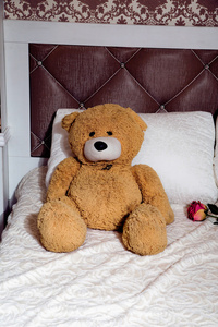 泰迪熊在古典家具床与枕头图片