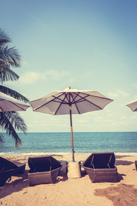 遮阳伞和热带沙滩的躺椅上