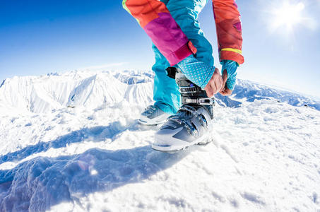女滑雪者系着她的靴子