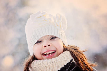 在雪林里特写可爱的快乐女孩的冬天肖像
