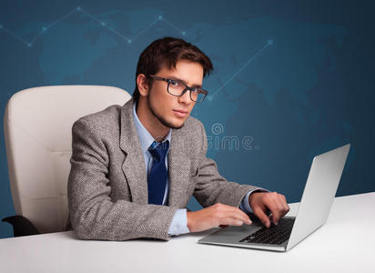 年轻人坐在桌旁，用笔记本电脑打字