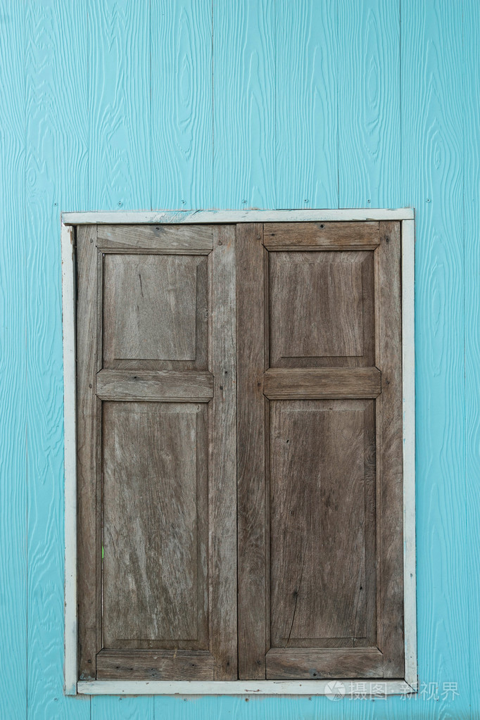 淡蓝色墙上的老式木门