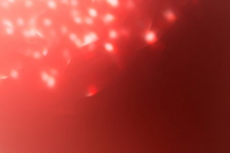 红色背景，抽象的散景轻的庆祝模糊背景