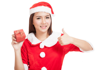 亚洲圣诞女孩竖起大拇指与圣诞老人衣服和红