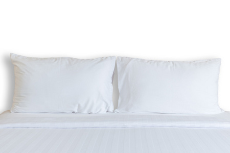 白色的床单和枕头在酒店的房间里